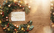© velikiyzayats - Christmas Party invitation card with pine wreath and festive decorations on rustic wooden background for winter holiday celebration design