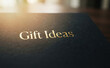 © velikiyzayats - Gift Ideas text printed on a dark surface with golden typography representing presents and shopping inspiration for special occasions