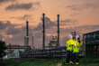 © BESTIMAGE - Industrial workers team discussing petroleum engineering in oil refinery project collaboration at fuel industry Male and female engineers using digital tablet at oil refinery site during sunset