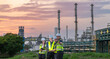 © BESTIMAGE - Technician teamwork inspecting petroleum engineering in oil refinery inspection check collaboration at fuel industrial plant Group of engineers using laptop and tablet for inspection evening time