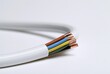 © Generative AI - White electrical cable with exposed copper wires and