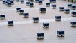 © twc - Autonomous mobile robots navigate across a large modern warehouse floor, performing automated inventory sorting and logistics operations efficiently