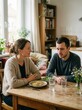 © 2Blurry - Young couple having a serious conversation while sharing a meal at the dining table at home