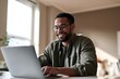 © Serhii - Confident professional in casual business attire working at a desk in a home environment