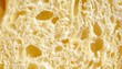 © Endin - Porous texture of golden artisan bread crumb cross section.