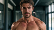 © Alive - Muscular man posing in a gym during a workout session in the morning