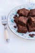 © Austockphoto - stack of chocolate gluten free brownie slices on plate at party