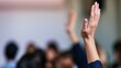 © tashechka - Participants raise hands during a discussion at an event in a large hall in a city