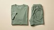© RestuAry - Green T-shirt and shorts laid out flat on a neutral background.
