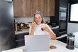© Metadancer - Middle aged white woman speaking on smartphone with coffee