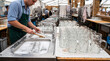 © Olga - Man cleaning beer steins in preparation for Oktoberfest event