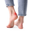 © New Africa - Woman with calluses on her foot against white background, closeup