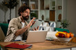 © Zoran Jesic - Man working from home using tablet and laptop