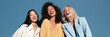 © Iryna - Three women laughing in pastel outfits against a blue background for social media header and lifestyle portrait