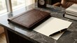© rezaul4022 - Executive leather portfolio, fountain pen, and paper document on marble desk in modern office