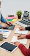 © Chanchai - Close view of hands in modest dress and headscarves working on a shared creative project with technology and stationery on a wooden desk, bright, creative, pencil