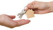 © Ioana - Isolated hands exchanging house keys with a wooden keychain, symbolizing real estate transaction.