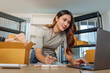© Natee Meepian - Asian Small Business Owner Checking Orders on Laptop for E-Commerce Fulfillment