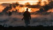 © MINTED VasitChaya - Atmospheric silhouette of a vintage World War soldier carrying a rifle, walking through smoky battlefield ruins at sunset, courage and remembrance concept with copy space.