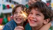 © Raul - Two happy children holding a sparkler at an outdoor party with colorful flags in the background.