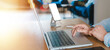 © Anchalee - Business Woman Typing On Laptop With Smartphone In Living Room, Working Online As Customer Service Adviser, Middle Aged Professional Using Technology In Remote Home Office And Hybrid Workplace.