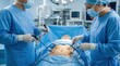 © RIOKO - Surgeons Performing Laparoscopic Surgery In Modern Operating Room With Patient