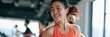© Andrii Zastrozhnov - Cheerful woman jogging on a treadmill in a bright gym interior for fitness background and wellness banner design