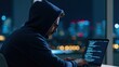 © Arfa_Media - Hacker in a hoodie using a laptop for cybersecurity coding as a software developer with digital network data tech