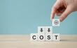 © irha - Hand placing white block with artificial intelligence icon on stack of cubes representing cost reduction for modern business technology operations