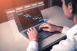 © InfiniteFlow - A professional engaged in project management on a laptop, using modern software to visualize tasks through an interactive Gantt chart, enhancing productivity and efficiency. Tessel