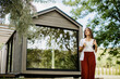 © BGStock72 - Charming moments of a woman enjoying nature by a modern cabin