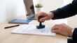 © Lee - hand stamping approved seal on official document, contract validation process, bureaucratic paperwork authorization, rubber stamp ink impression, administrative task completion