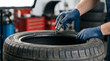 © Waroeng Vector - Technician Repairing or Inspecting a Car Tire Using a Digital Device in a Workshop Environment