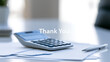 © A2Z AI  - Business office desk with calculator paper documents and metal pen with text thank you overlay for corporate gratitude concept banner photo