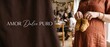 © Dinali - Pregnant woman holding baby booties at cozy baby shower party with friends in warm indoor setting, expecting mother celebrating new life and motherhood concept with copy space and rustic decor.