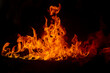 © Travel 'n' Lifestyle - View of a vibrant bonfire with bright orange and red flames flickering against a dark background in Multan, Punjab, Pakistan.