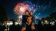 © Heorhii - Children sitting on father's shoulders watching fireworks at night, family celebration