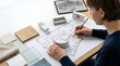 © SnapSpark Studios - Interior designer sketching floor plan with furniture models, architect working on home renovation layout, professional room planning