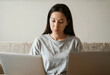 © Pixel-Shot - Burnout and remote work stress, young woman multitasking with two laptops at home feeling overwhelmed by digital workload and professional deadline pressure
