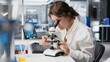 © DC Studio - Histology technician uses a microscope for cellular analysis in a laboratory, examining microorganisms with optical equipment in a research facility.