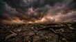 © MUdaylah - Dramatic stormy sky over dry cracked earth and dead leaves representing climate change and environmental crisis