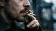 © fazlul - Close up of a man with a beard smoking a cigarette outdoors