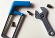 © Angelov - wall-mounted tool organizer in a workshop. Row of steel hand tools of various sizes for mechanical and repair work