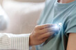 © Natee Meepian - Doctor examining patient chest with stethoscope and glowing EKG pulse line overlay