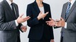 © Yuna - Corporate business team discussion featuring three professionals in formal suits gesturing during meeting, negotiation conversation, partnership agreement dialogue