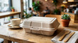 © ZoshPixels - Sustainable paper takeout container for food served on a wooden table