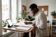 © SR07XC3 - Young African man sketching portrait at bright home studio desk