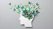 © MDMITHAN - Conceptual image of a human head dissolving into lush green trees representing growth nature and mental wellbeing