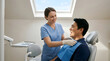 © Komang - Dentist, patient and clinic with bib for checkup, oral health and medical procedure. Professional, healthcare and appointment with expert, treatment and tooth care in office with service.