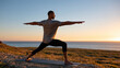 © Nataliya - Indigenous man practicing yoga outdoors at sunrise, wellness, flexibility, mindfulness, healthy lifestyle, nature connection, peaceful landscape, with copy space